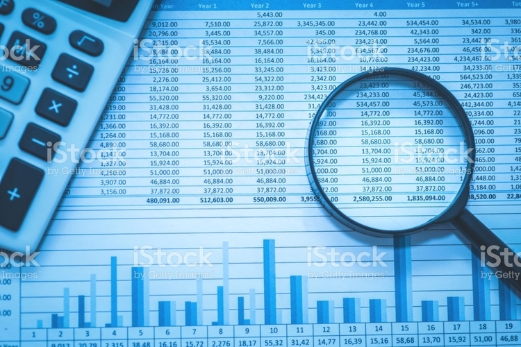 magnifying glass on top of an expense report